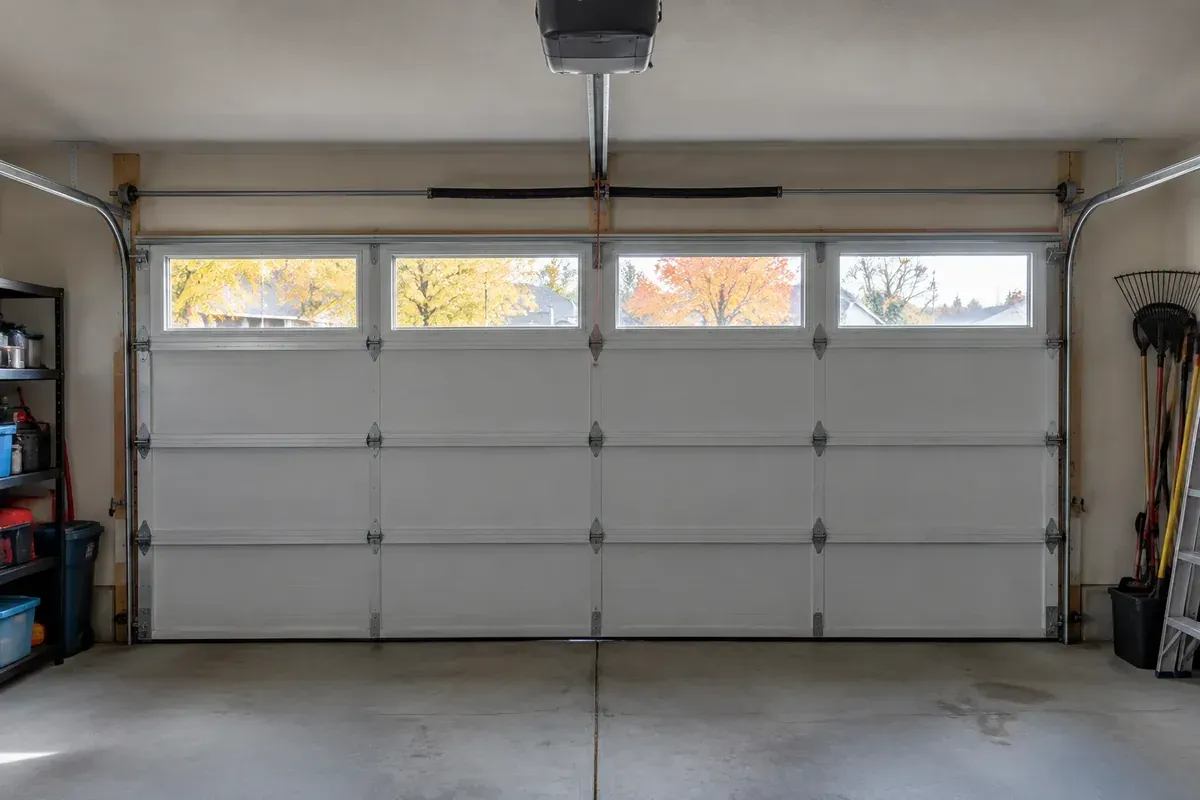 Closed garage door not working after pulling red cord, with the opener rail and release cord visible.