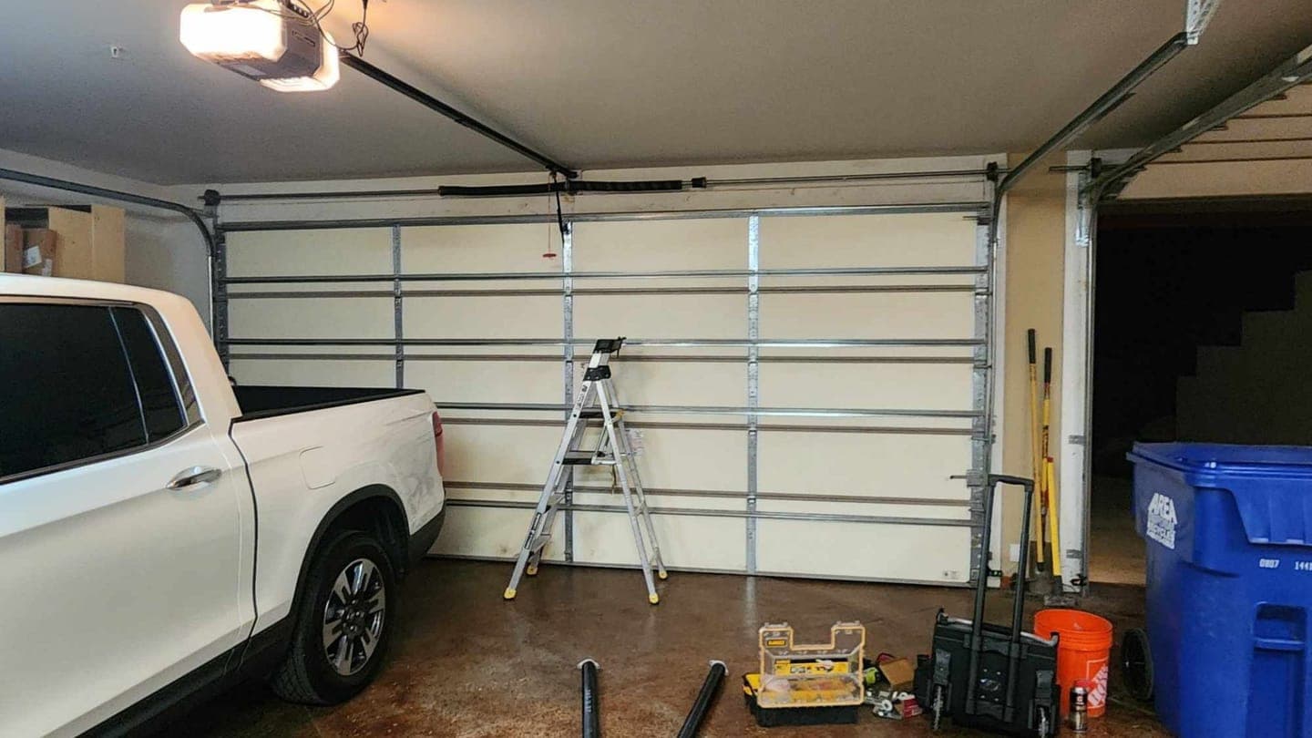 Garage door torsion spring, tracks and opener inside a home garage